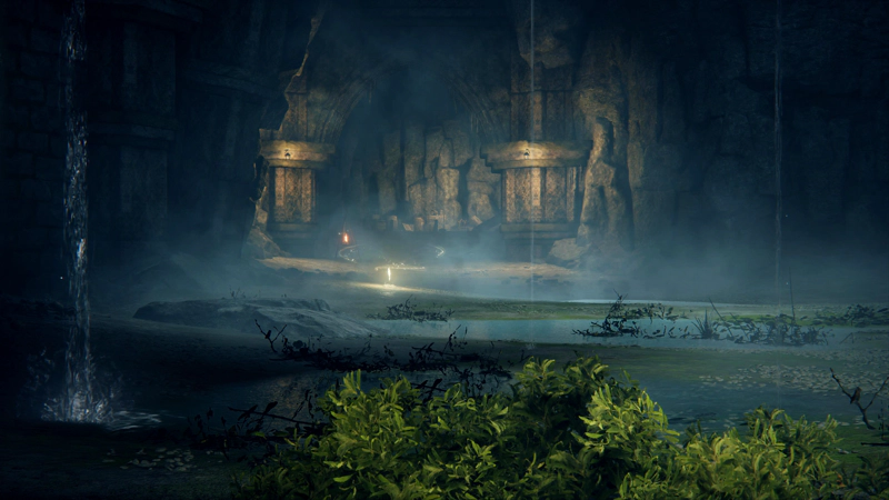 A shining golden grace, surrounded by glowing arcs, at the far edge of a series of shallow underground pools. A large clump of greenery sits in the foreground, where a rivulet of water streams from high above.