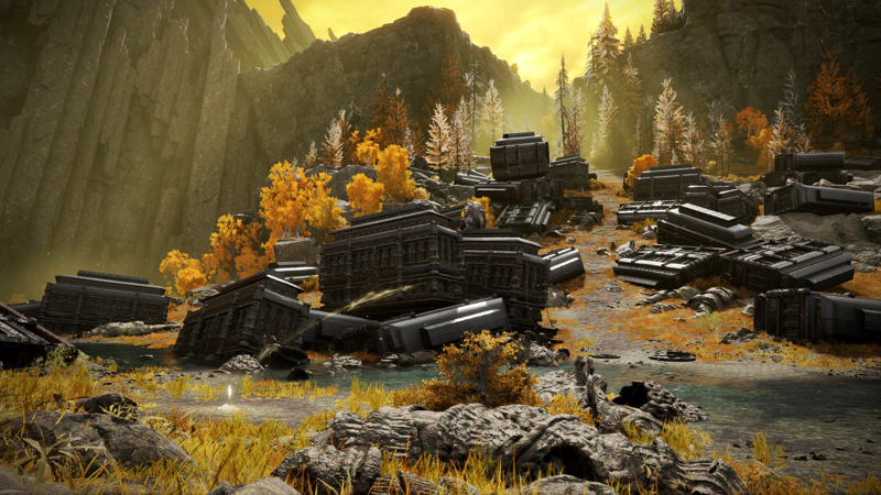 A graveyard of large, obsidian carriages, scattered and ruined, beneath a towering grey cliff. The whole scene is awash with golden sunlight, carving a path through the wreckage and surrounding trees, and in the foreground lies the broken remains of a stone giant.