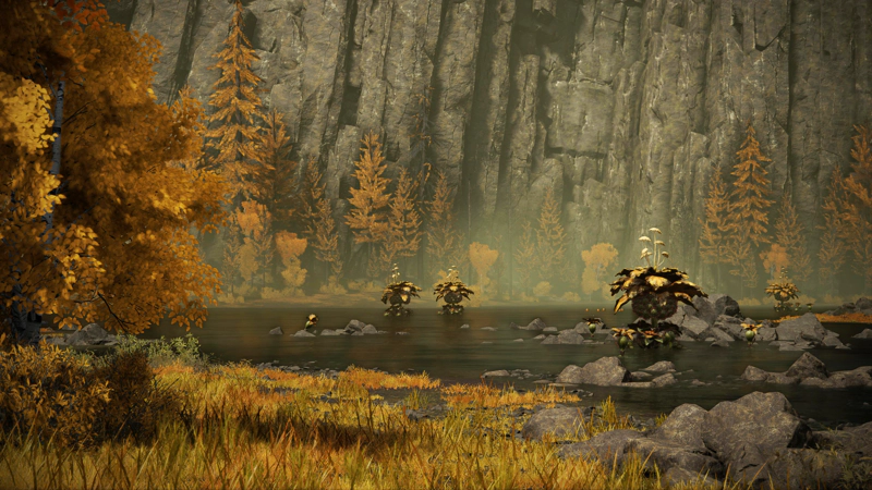A wide grey-green lake beneath tall grey cliffs, with a number of large, ominous-looking golden flowers in the water. A slope of variegated brown grass leads to the water's edge, beside a tree rich with autumn leaves.