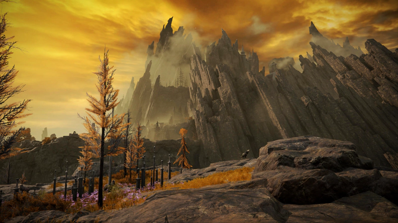 A sword memorial, on a flattened peak. Beyond, a volcano rises into the sky, with multiple layers of overlapping basalt peaks, jagged and broken like fangs.