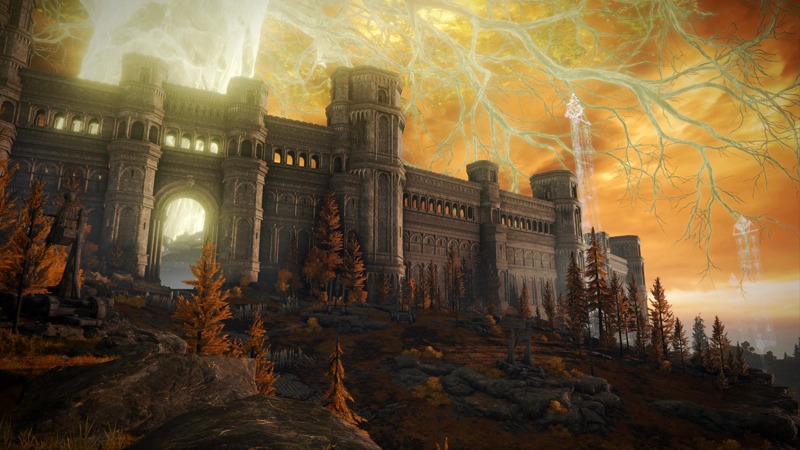 A view past catapults and barricades of wooden stakes to the walls of the Capital, and the shining trunk of the Erdtree beyond. The walls curve out of sight to the right, and above, the golden branches of the Erdtree creep across a clouded orange sky.