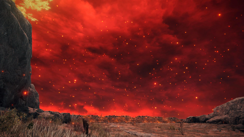 A broken paved road leading to a burning wall, beneath a wide crimson sky, full of drifting embers.