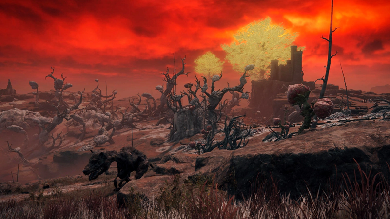 A monstrous dog stalks along a grassy path. Behind, rolling pink slopes descend towards the swamp. The landscape is scattered with twisted, corrupted trees, bare except for strange growths, and in the distance two golden erdtrees gleam against a bright scarlet sky.