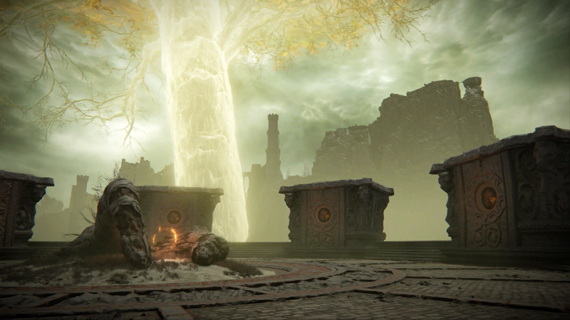 The top of a circular tower, looking past the golden Erdtree to a tower and snowy mountaintops beyond. A large pair of decaying fingers sit in the centre of the tower, around a glowing red rune.