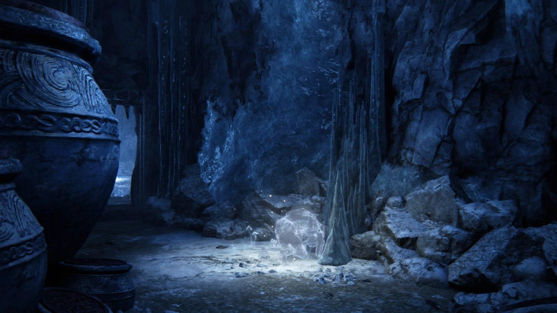 A spectral figure kneels in an icy cavern. Vast ceramic pots obscure the left-hand side of the frame, and beyond them, a portcullised doorway leads deeper into the cave system.