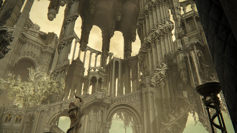 Looking up through the spiralling city of Enir-Ilim. An arched viaduct supports a ceremonial staircase which leads up to a large central pillar, wrapped in a vast carved spiral motif. High above, pillars descend from the heights, and in the distance more rising viaducts reach into the sky. The whole city is a pale grey monochrome, washed with wan golden light.