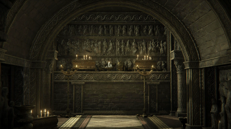 An arched corridor of grey stone, terminating in an ornately-decorated wall with three rows of carved figures, weathered by time. A pair of golden boxes topped with burning candles sit amongst a variety of other ceremonial-looking objects, and two horned candlesticks are stood on the floor in front of the display. The floor is patterned with white, black and pink mosaic tiles, and is lit by a beam of sunlight from the left.