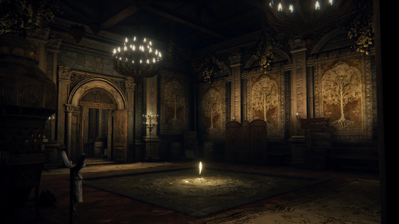 A palatial chamber, looking a little worse for wear. There are golden Erdtree tapestries on the walls and ornate chandeliers hang from the ceiling, but there are wooden boxes stacked haphazardly in corners and the centre of the floor is rough dirt. A shining shard of grace rises above the dirt, lighting its surroundings.