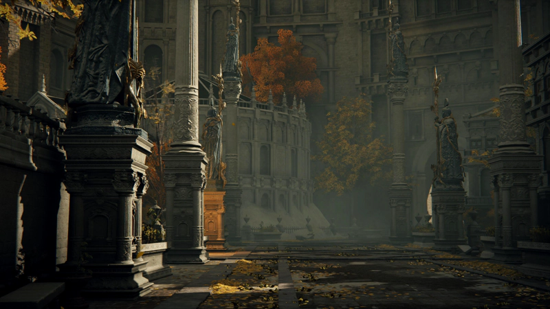 A wide avenue through the Capital. The street is scattered with reflective golden leaves, and the late-afternoon sun makes the tall statues lining the way cast long shadows.