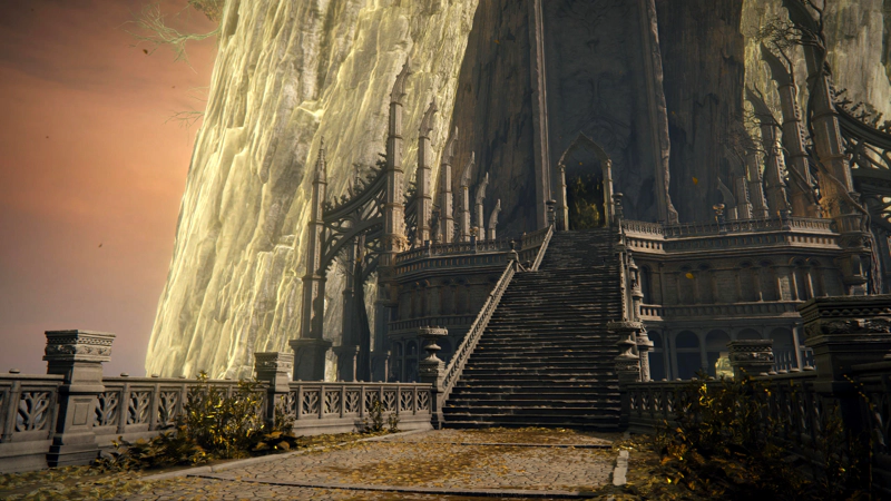 A wide processional staircase, leading up to a large archway in the shadow of the Erdtree. To either side, large decorative buttresses frame the ceremonial plaza.