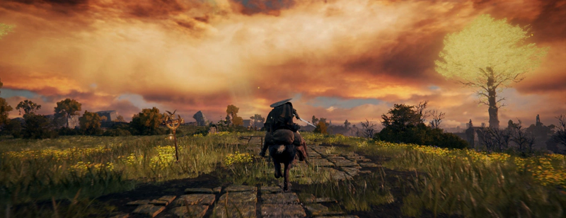 A confessor rides her horse along a paved road, overgrown with grasses and wildflowers. The sunset clouds are a burst of amber light, and to the right a minor Erdtree stands tall, glorious in its golden canopy.