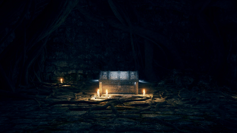An ornate grey treasure chest, lit by candles. The floor and walls are covered in dark roots.