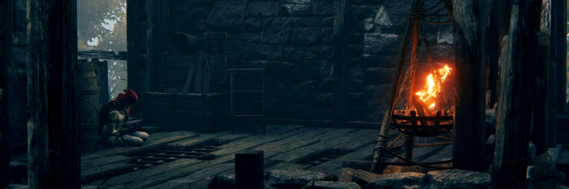 A girl in a red cowl sits slumped against a barrel, in a broken-down old shack. A brazier is lit on the other side of the room.
