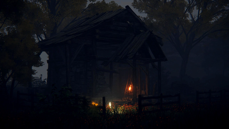 A ruined shack at night. The brazier and the grace cast colourful light against the front of the building, and a shock of red flowers glow in the foreground.