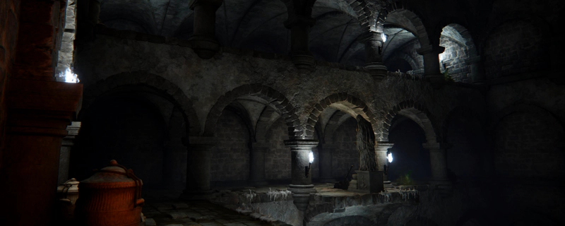 A two-level catacomb of stone arches, lit by bright white torches in metal fixtures. A statue stands on a promontory with a metal lever beside it.