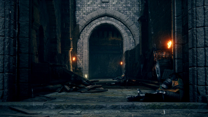 A rain-soaked castle entranceway. Debris is scattered across the path, and the corpses of human soldiers lie crumpled against the stonework.