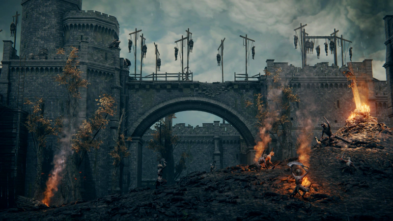 A panorama across a burning castle-scape. Bodies hang from gibbets above battered stone arches. In the foreground, beasts stand on their hind legs on a scree slope of rubble.