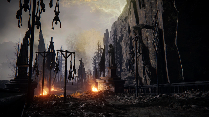 A bridge awash with corpses, both piled on the roadway and hung inverted from wooden poles. Robed statues stand guard over fires still burning on the battlefield beyond. In the far distance, the sky is bright around the golden light of a minor Erdtree.