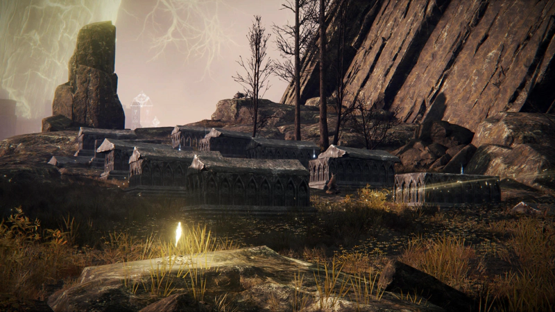 A mountainside graveyard, two rows of heavy stone coffins in various states of disarray. The sun is shining against the smooth cliffs, and in the foreground a shard of grace glows golden.