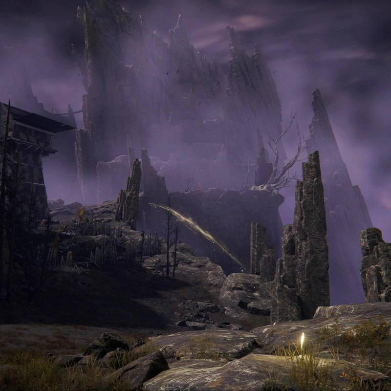 A shard of grace glows on a grey rock, projecting an arc of golden light up a winding mountain path, past siege towers and wooden stakes into a series of jagged peaks, cloaked in purple fog.