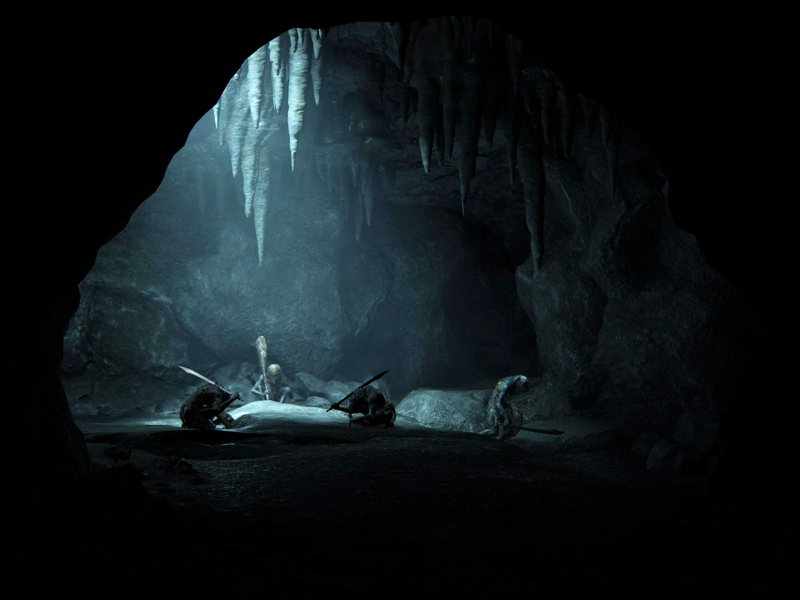 Four demi-humans crouch in a cave, washed pale blue by a shaft of light from above. Stalactites hang from the ceiling.