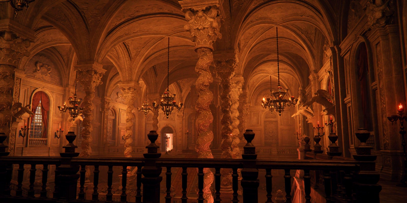 A view from a balcony across a lavishly-decorated audience chamber. The vaulted ceiling is held up with spiralling carved columns, and each cross-point in the vaulting is accompanied by a chandelier. Arched windows down each side are partially obscured with red velvet curtains, and accompanied by winged-lizard gargoyles.