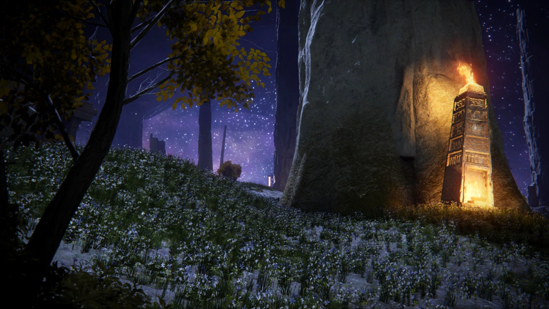 A field of small white flowers beneath a purple starry sky. A small tree frames the left of the scene, and to the right, a flame-topped stele  stands against a rough-hewn stone pillar.