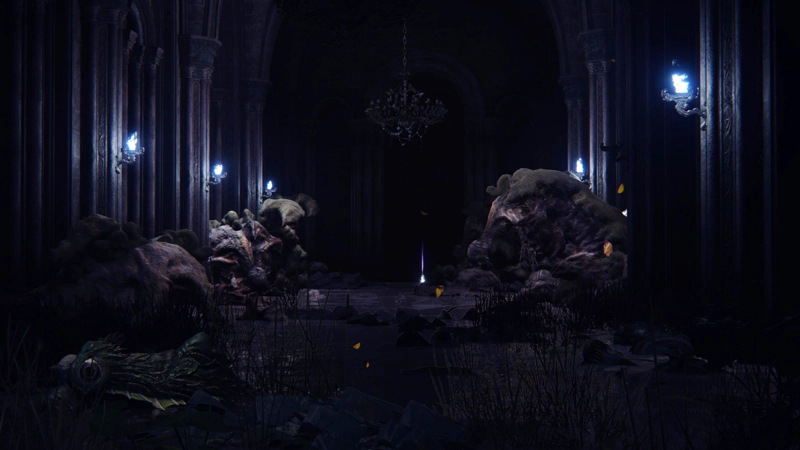 A dimly lit chamber, with high, arched ceilings, filled with the corpses of half-formed gargoyles, slumped against the walls. Blue-white torches light the scene, and a purple wisp rises from a human-sized corpse at the centre of the room.