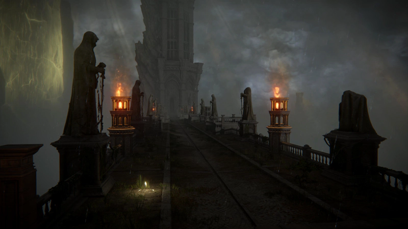 A gloomy bridge towards a divine tower, lined with statues in various states of ruin and flaming braziers. The clouds above are thick and grey, full of rain; even the golden trunk of the Erdtree - to the far left - is muted by the weather.