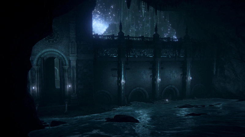 A subterranean stone dam lit with pale blue light, with arched sluice gates. Water surges across the floor around partially submerged rocks, and to the left, steps lead up to an archway. Above the dam grey-stone buildings hang from the ceiling, scattered with purple stars.