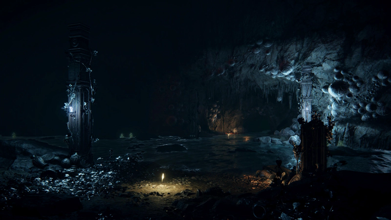 A shard of grace in a dimly-lit cave, strewn with small white flowers. Broken pillars stand beside shallow waters, and the tunnel roof beyond is heavy with large eggs.