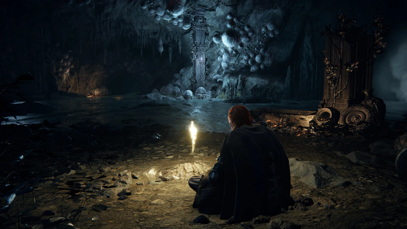 A red-haired confessor sits underground, beside a glowing golden shard of grace, its light blooming through her hair. Broken pillars stand beside shallow waters, and the tunnel roof beyond are heavy with large eggs.