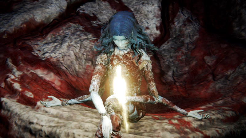 The unclothed body of Ranni's doll sits underground, surrounded by the blood-drenched flesh of the Two Fingers who she has slain. A shard of grace rises before her, shining golden light upon the scene.
