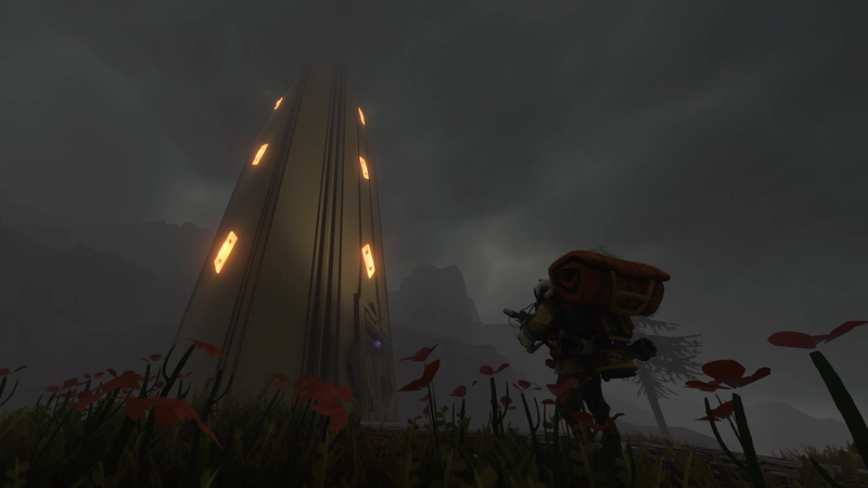 An astronaut stands before an alien shrine. Their surroundings are grey and clouded, but small red flowers fill the foreground.